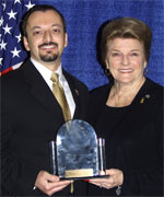 Dean Gialamas, Director of the Forensic Science Services Division (left), accepts the award for the Orange County Sheriff's Department's PEBT Program from POST Commission Chair Collene Campbell